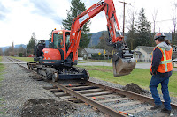 Trackhoe works on repairing tracks in February after January 2009 flood damage.