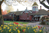 Snoqualmie Depot with locomotive 4012 and Weyerhaeuser Caboose and flowers during Save Our Rails event.
