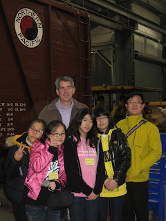 Photo by Tina McCollum, left to right in front: Hye Jin Yun, Jeong Min Lee, Min Seon Jung, and Hwa Yeon Kim. At the back, Snoqualmie Mayor Matt Larson, and Gangjin Education Director Seon Gil Kang.