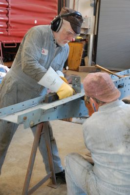 Two men riveting.