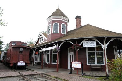 New interpretive sign at Snoqualmie Depot with caboose on siding.