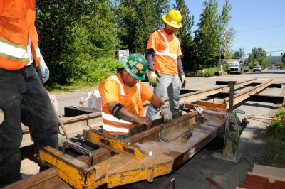 A jig is used to align two lengths of rail prior to thermite welding.