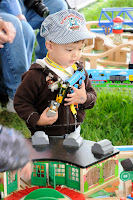 Sam from Shoreline assembled a lengthy and colorful train on the wooden railway train tables while visiting Day Out With Thomas.