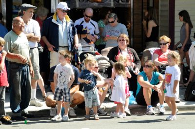 Kids and adults wait along Railroad Ave during the Snoqualmie Railroad Days parade.