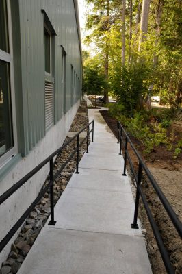 A new walkway around the Train Shed is seen with newly planted native plants along the walkway.