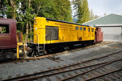 Weyerhaeuser Timber Co. #1 and White River Lumber Co. caboose #001 with a museum diesel outside the Train Shed.