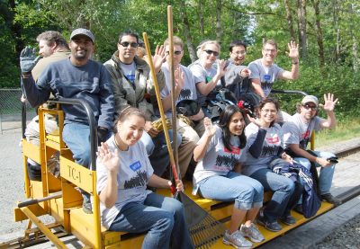 Microsoft volunteers aboard the speeder trailer waving to the camera.