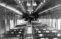 Interior view of Messenger of Peace for the turn of the century. Pews are set up in the car, and "Messenger of Peace" is written on the blackboard at the lectern.