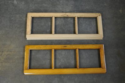 Rebuilt Messenger of Peace clearstory windows. One is raw wood, the other is has shellac, showing the difference.