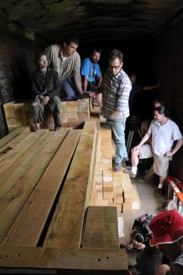 Lumber is stacked in a former NP boxcar. Flim crew and actors for "You Can't Win" stand around and sit on the lumber.