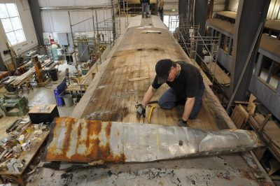 Original Terne metal roof being removed from Messenger of Peace by Gary. Holes in the roof for the original lamps can be seen further back in the roof. SP&S 218 can be seen on the track to the side, undergoing its own restoration.