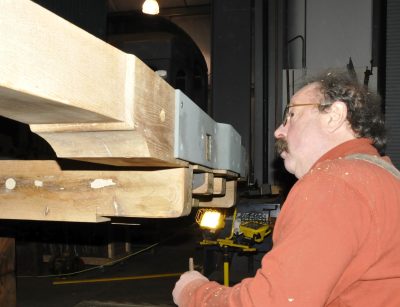 Lead rehabilitation specialist Kevin P. works on the new end beam for Messenger of Peace.