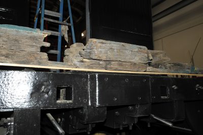 The original badly deteriorated end beam for Messenger of Peace sits on top of the replacement beam installed on the car.