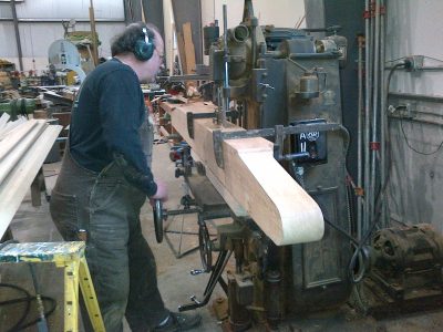 A worker mills a new end beam on the Northfield chain mortiser in the CRW for Messenger of Peace.