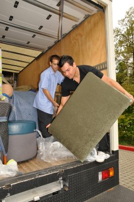 Queen Anne Upholstery workers unload seat cushions for Union Pacific 1590.