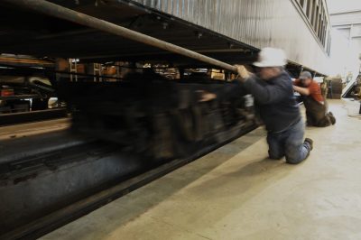 Workers roll rear truck under Messenger of Peace.