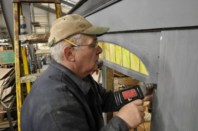 Bob McN. installs an arched colored glass window on SP&S 218.