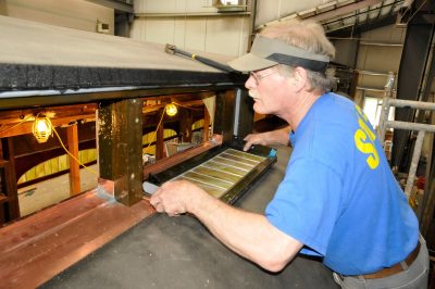 Volunteer installs a clerestory window on SP&S 218.