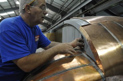 Bob M. attaches the last clerestory panels to allow attachment of copper panels to roof of SP&S 218.