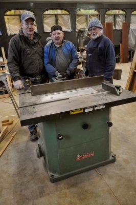 Volumteers stand benhind the new Northfield Model #4 table saw.