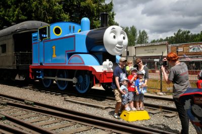 A family poses for a photo with Thomas for a JED Photography photographer during DOWT 2014.