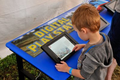 A young visitor plays on a tablet as part of DOWT 2014.