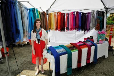 A vendor shows off a rainbow array of hand-made scarves during SRD 2014.