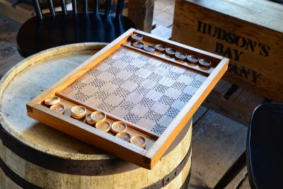 Wooden checkers set at Fort Nisqually, 2015.