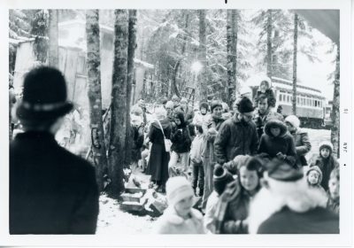 Families line up to see Santa under the gaze of a Keystone Cop. Taken during Santa Train 1975.