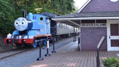 Thomas the Tank Engine riding the rails past Snoqualmie Falls Depot.