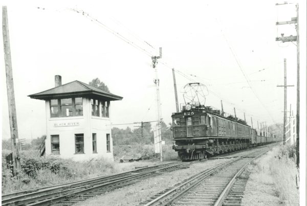 A Milwaukee Road electric boxcab pulls a freight past Black River tower in Tukwila circa 1935. Charles Turner photo.