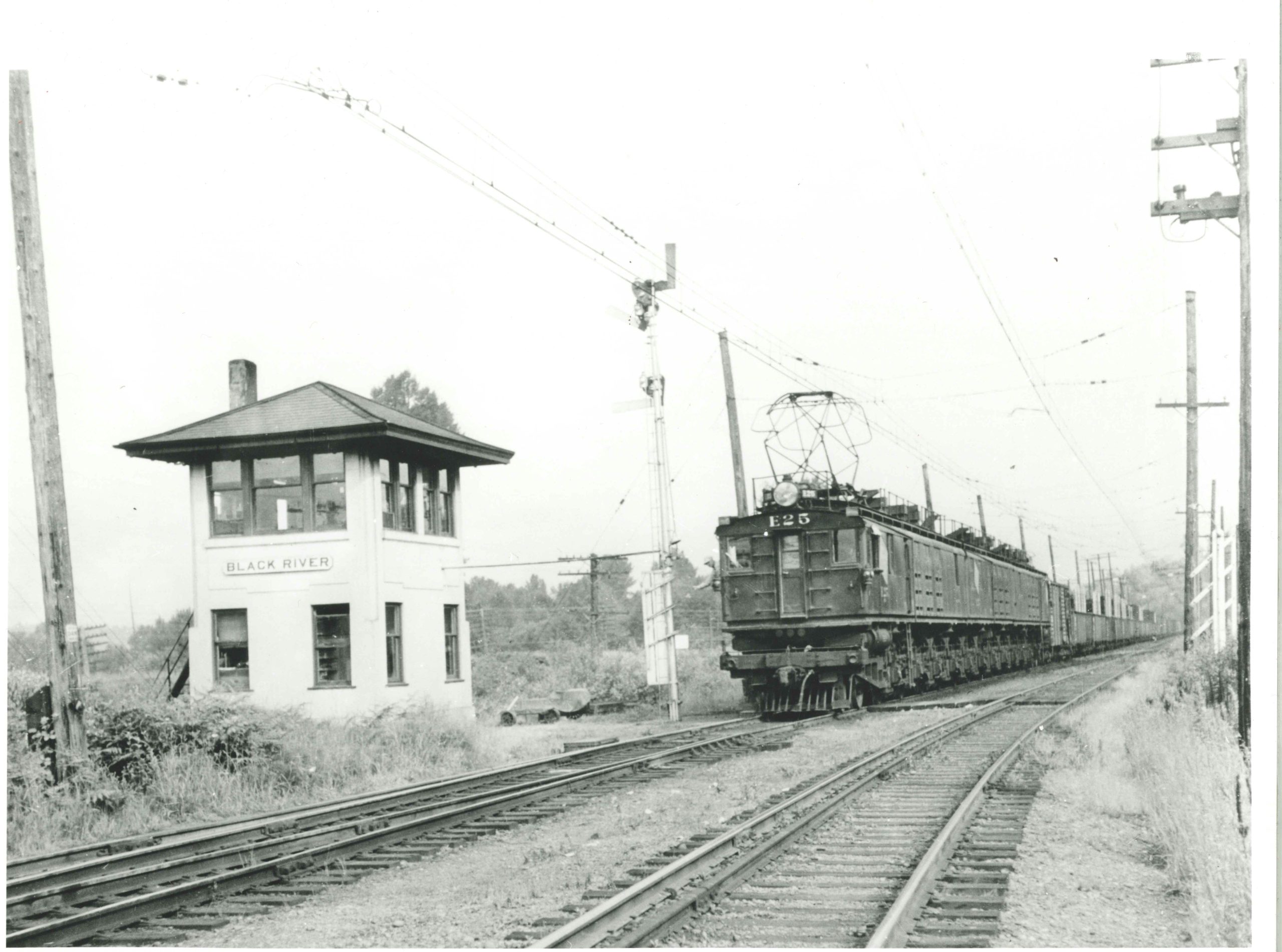 A Milwaukee Road electric boxcab pulls a freight past Black River tower in Tukwila circa 1935. Charles Turner photo.