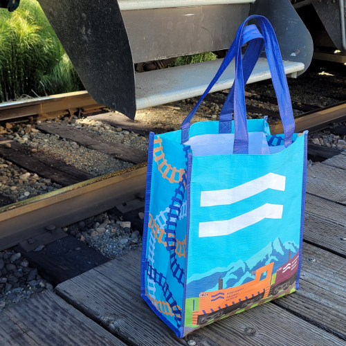 An NRM tote bag next to the steps of one of the coaches.