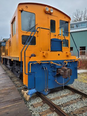 SVR 4024 at the Railway History Campus. Volunteer Aiden S. is working under the locomotive with his legs sticking out. A Blue Flag is hanging off the handrail on the locomotive.