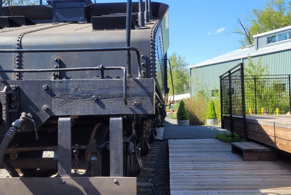 Northern Pacific 924 and tender sits next to the REC platform. The handrail from the locomotive sticks out into the edge of the platform.