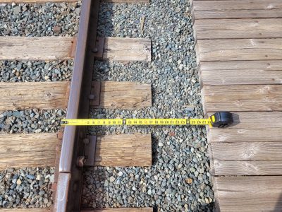 A measuring tape sows the distance from the inside of the rail to the platform.