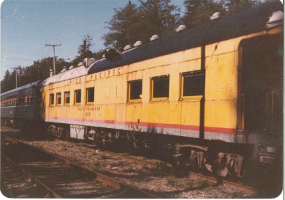 Union Pacific Café-Observation 1590 upon arrival at Snoqualmie as Rules Examiner 205. The car is painted in UP Armour Yellow with a gray roof and a gray and red stripe at the bottom.