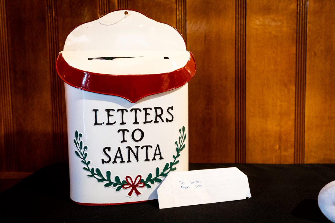 Letters to Santa box inside the Chapel Car, a child's letter sits in front of it.