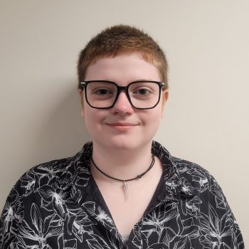 Staff member with short hair in a floral shirt