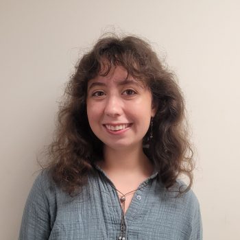 Staff member with long hair in a blue shirt.