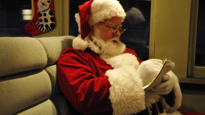 Santa checks his list aboard one of the Museum's coaches. Yuletide Express