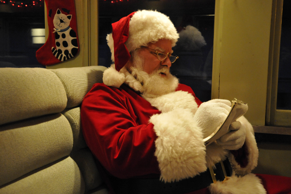Santa checks his list aboard one of the Museum's coaches. Yuletide Express