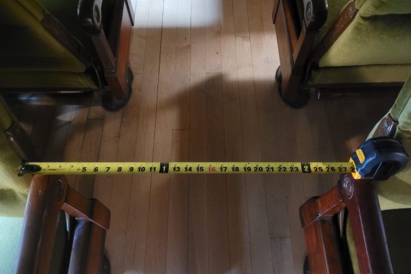 The aisle within coach 218, the space between the arms of each row of seats measures approximately 25 inches wide.