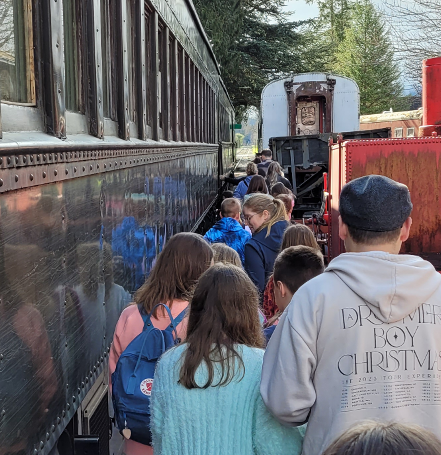 Students and chaperones lined up to board the train on a field trip visit to the Museum