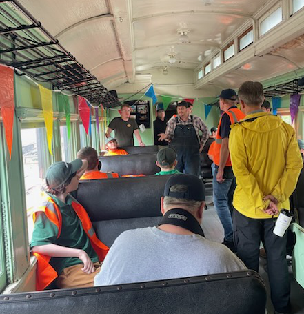 A Museum educator and volunteers give some visiting kids a talk about rail safety aboard the train.
